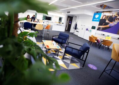 A shot of the co-working space at the Wood Centre for Innovation showing tables, chairs and desks.